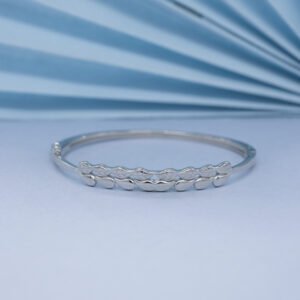 Sterling silver engraved leaf bangle, mirror finish, styled on blue, by Luxer